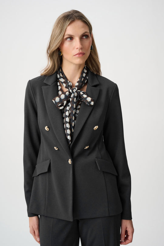 Black fitted blazer with brass buttons, notch lapels, and flap pockets.