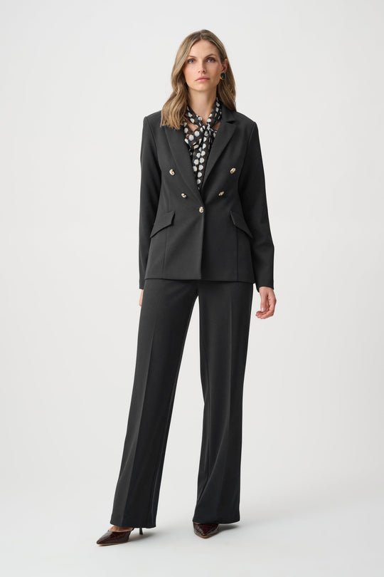 Black tailored blazer with brass buttons and flap pockets, long sleeves.
