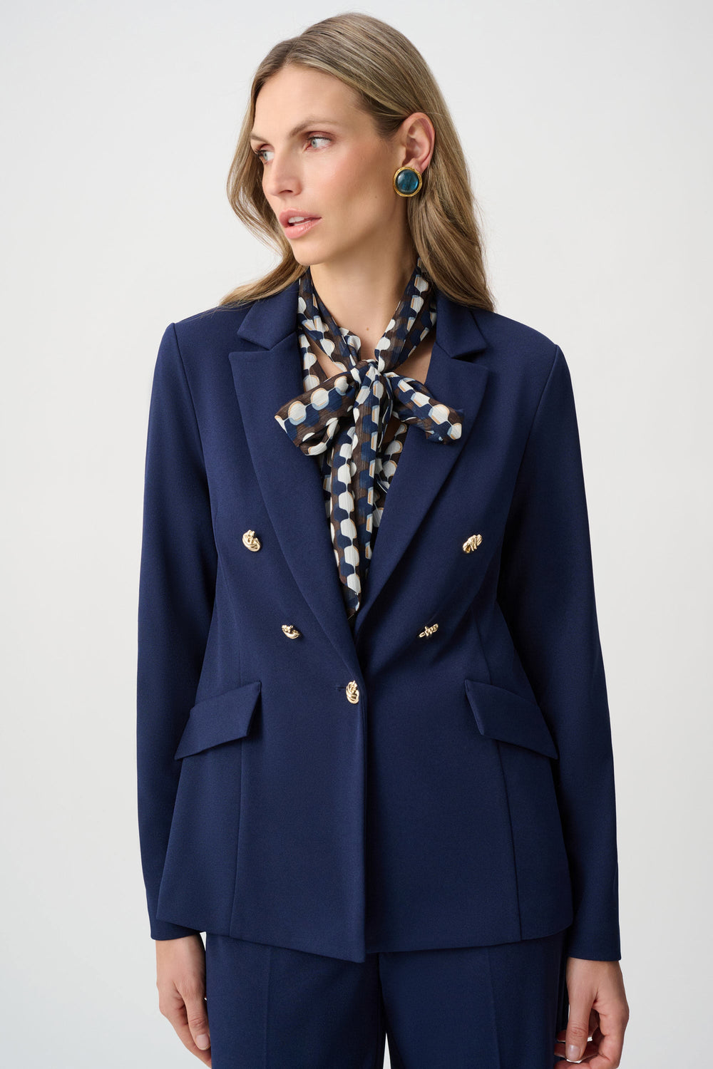 Indigo fitted blazer with brass buttons, peaked lapels, and flap pockets