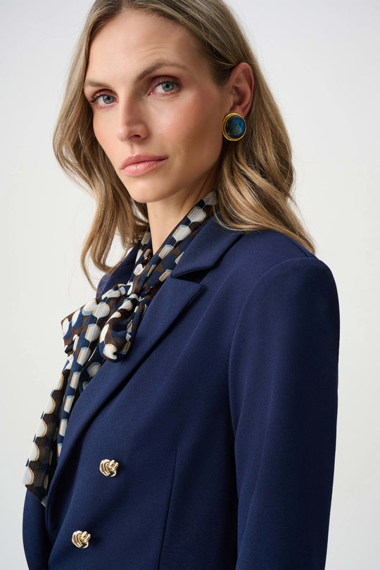 Indigo blazer detail with brass buttons and structured shoulder seams