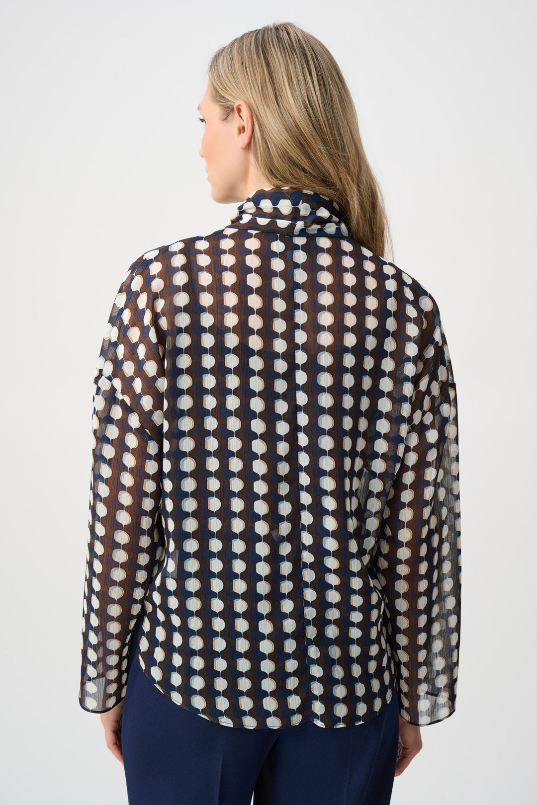 Back view of tie-neck chiffon blouse with brown and navy geometric pattern