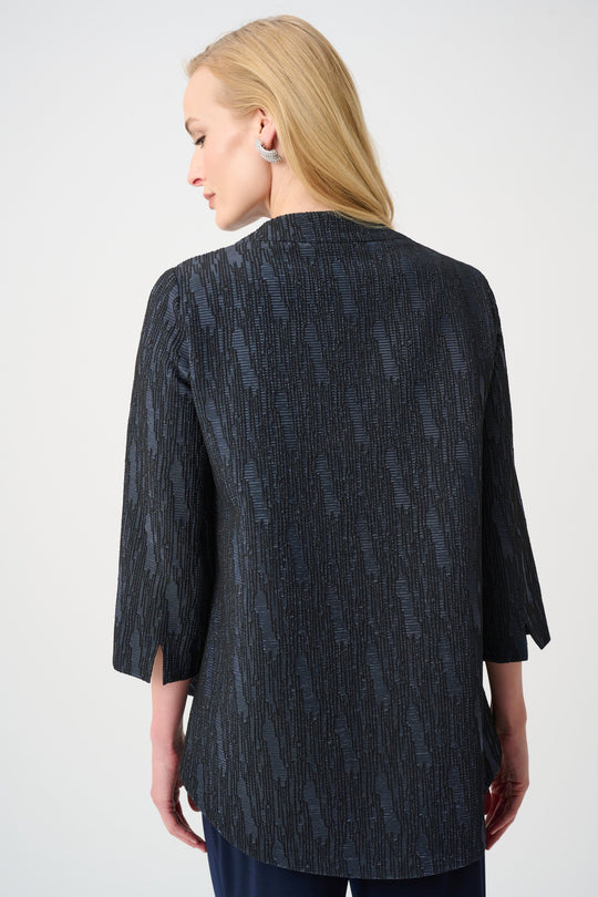 Textured navy jacket with three-quarter sleeves shown from back, trapeze silhouette