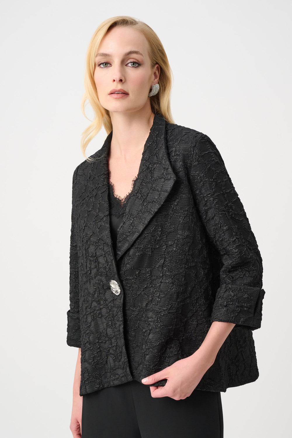 Black textured jacquard trapeze jacket with single button closure worn by model