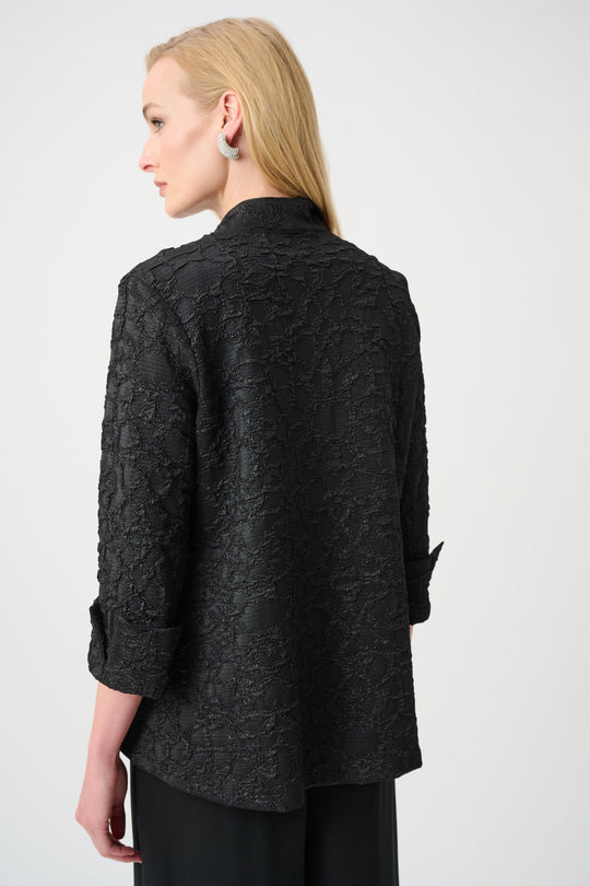 Black textured jacquard trapeze jacket shown from back view on model