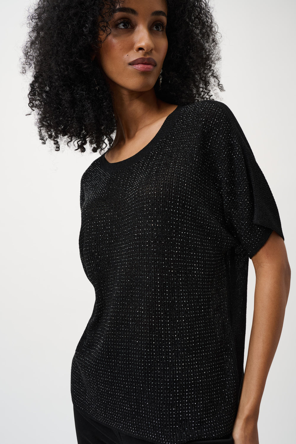 Black metallic knit short-sleeve top with sparkly rhinestone detailing worn by model