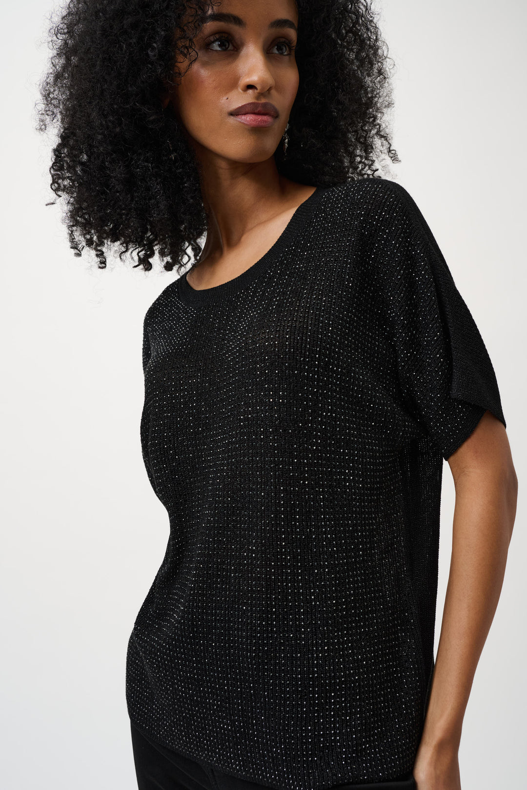 Black metallic knit short-sleeve top with sparkly rhinestone detailing worn by model