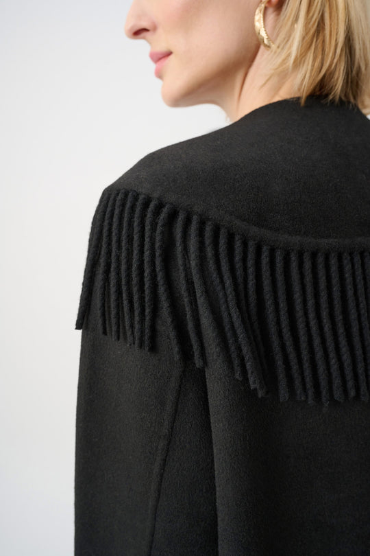 Black wool-blend coat with shawl-collar fringe tassels along the neckline