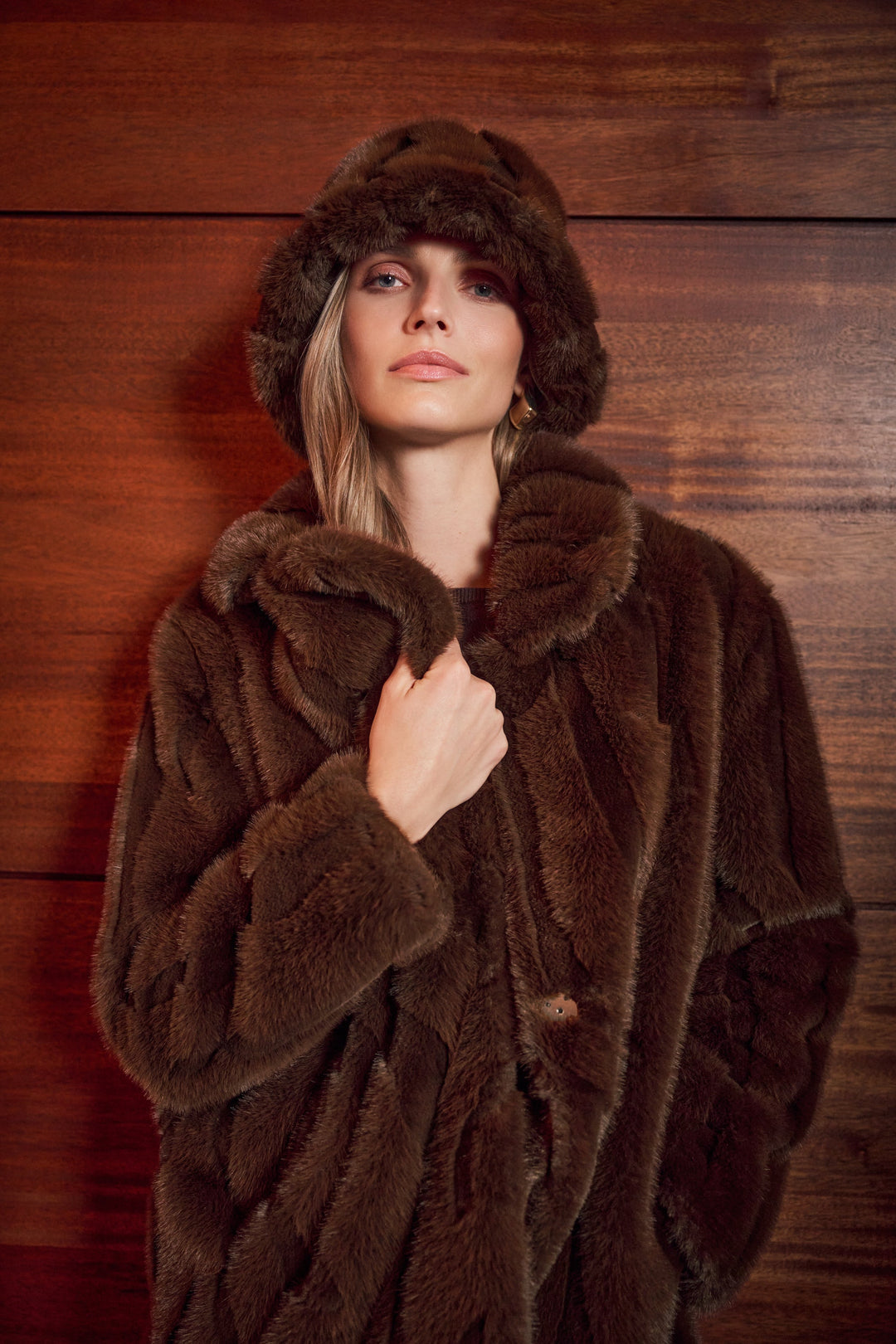 Brown faux fur notch lapel coat collar and textured plush fabric close-up