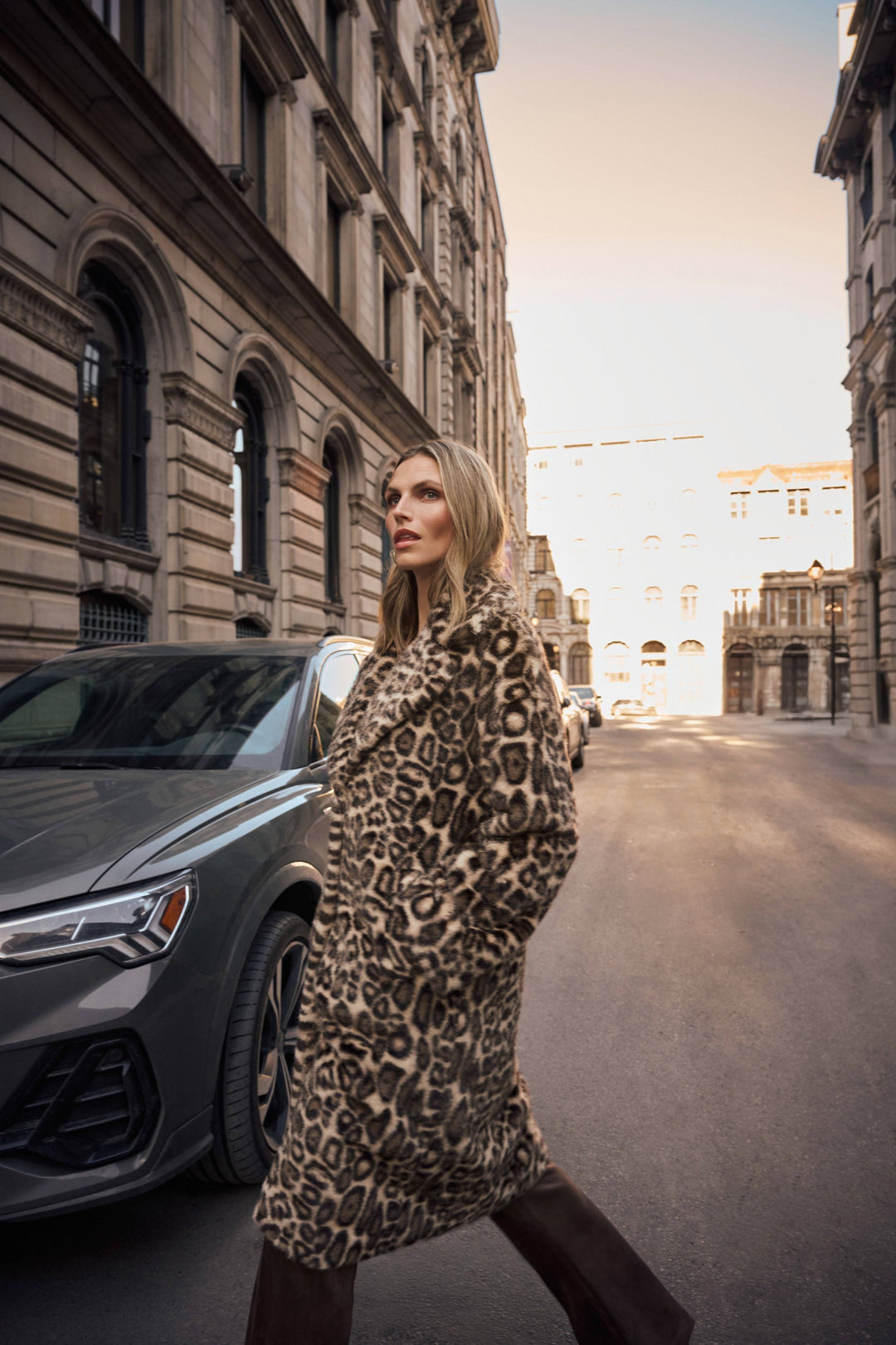 Leopard print faux fur coat worn outdoors, long sleeves and button-front