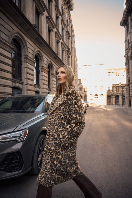 Leopard print faux fur coat worn outdoors, long sleeves and button-front