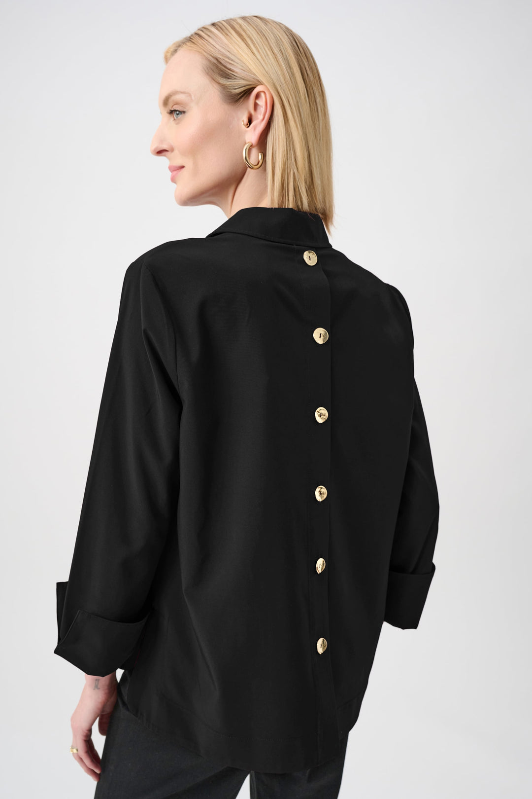 Black boxy top with back yoke, buttoned placket, and 3/4 turnback sleeves