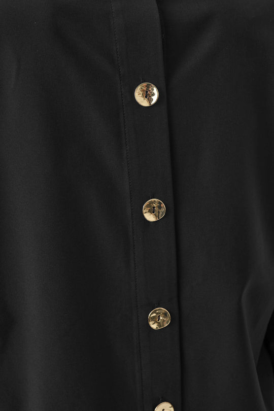 Black boxy poplin shirt with front half placket and button closure, shirt collar visible
