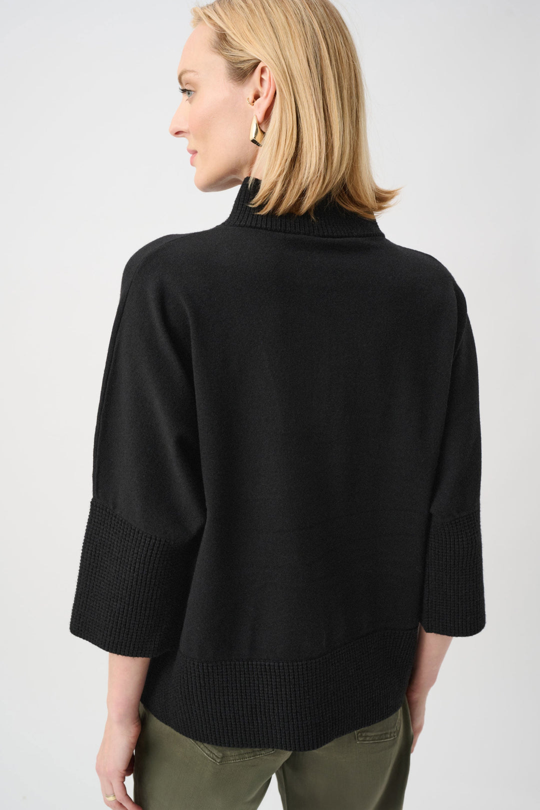 Black funnel-neck sweater with ribbed hem and relaxed back drape