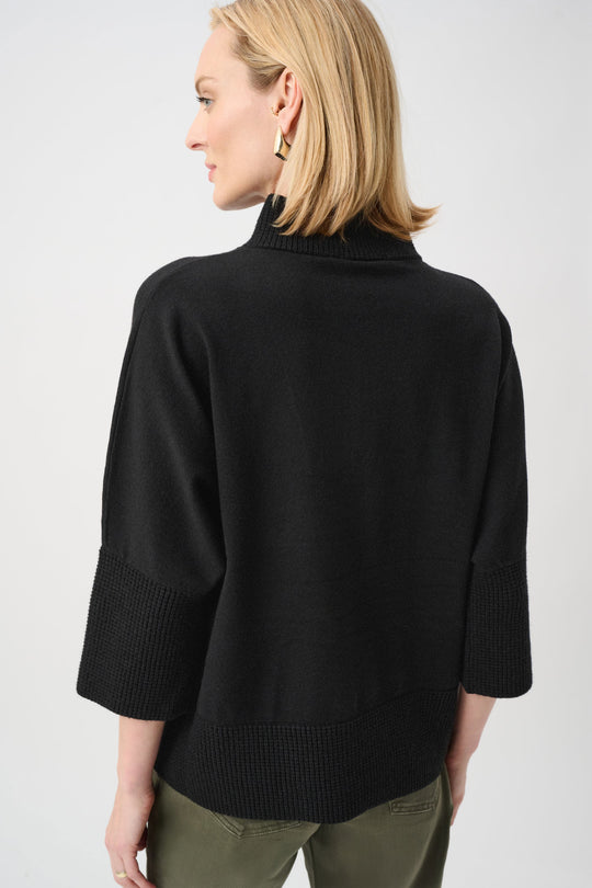 Black funnel-neck sweater with ribbed hem and relaxed back drape
