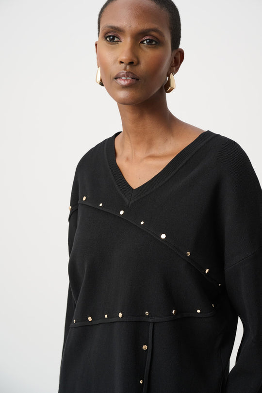 Black asymmetric V-neck sweater with diagonal gold metal stud line across front