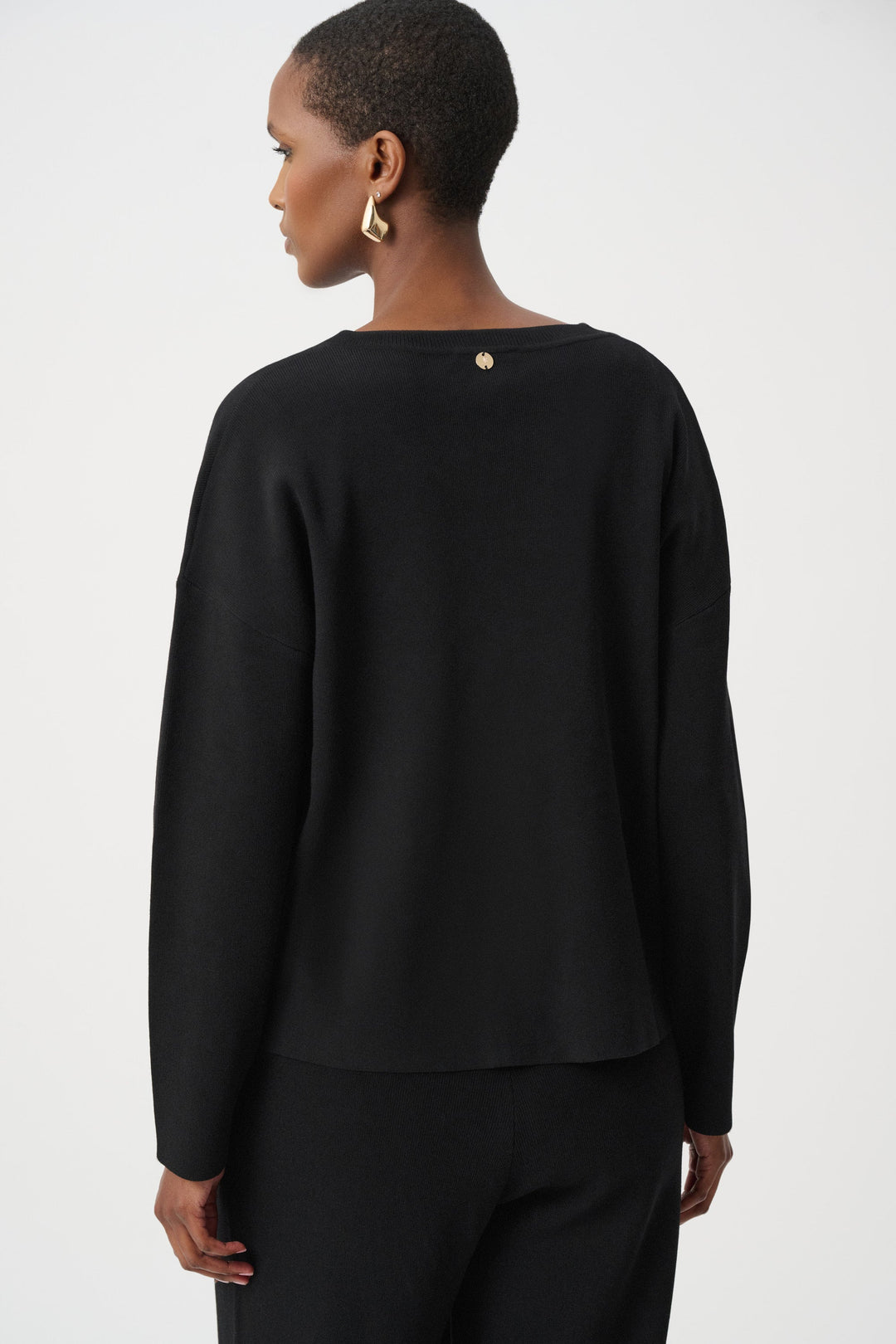 Black asymmetric V-neck sweater back view with gold metal stud details