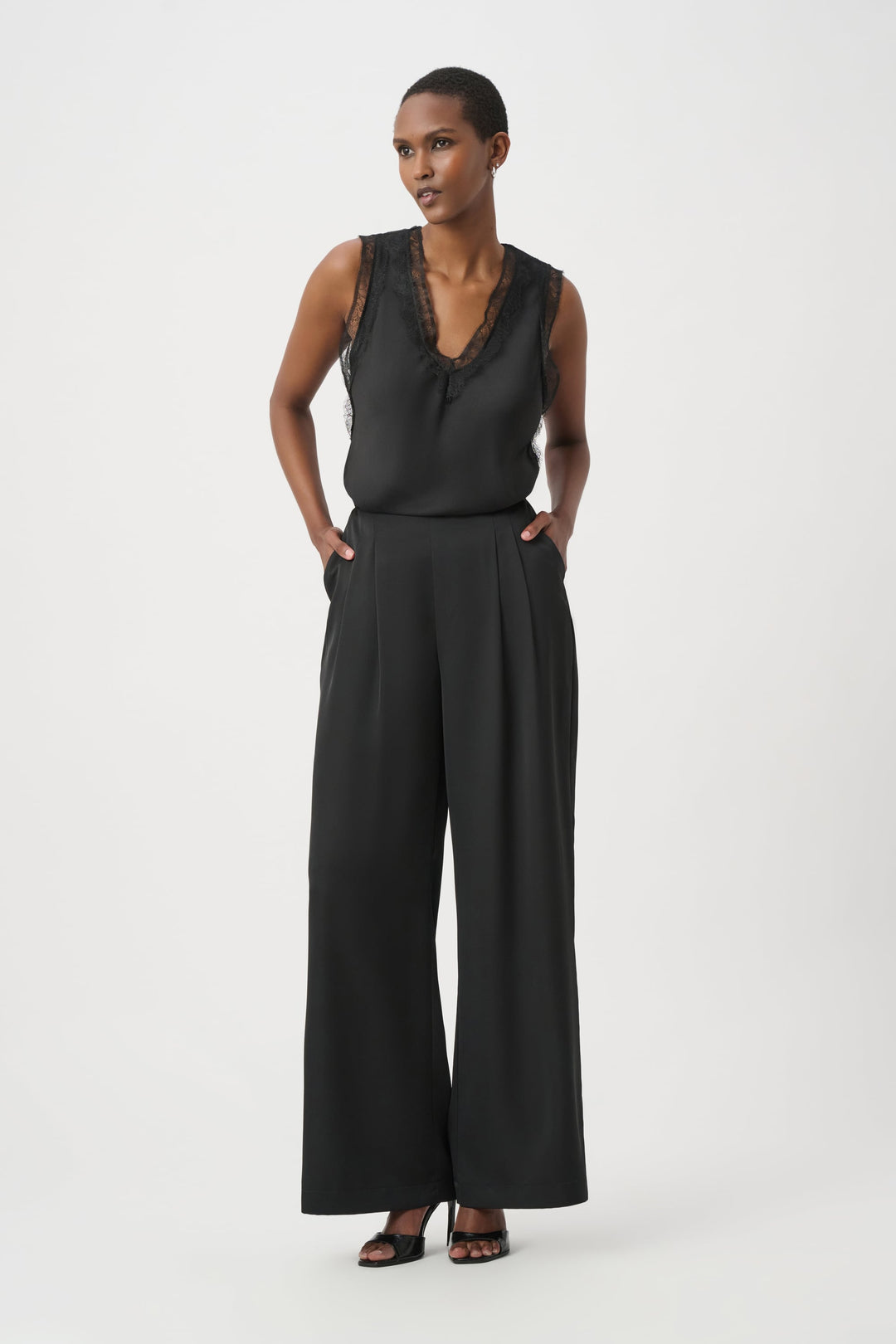 Black satin sleeveless V-neck tank with tiered hem and lace-trim neckline