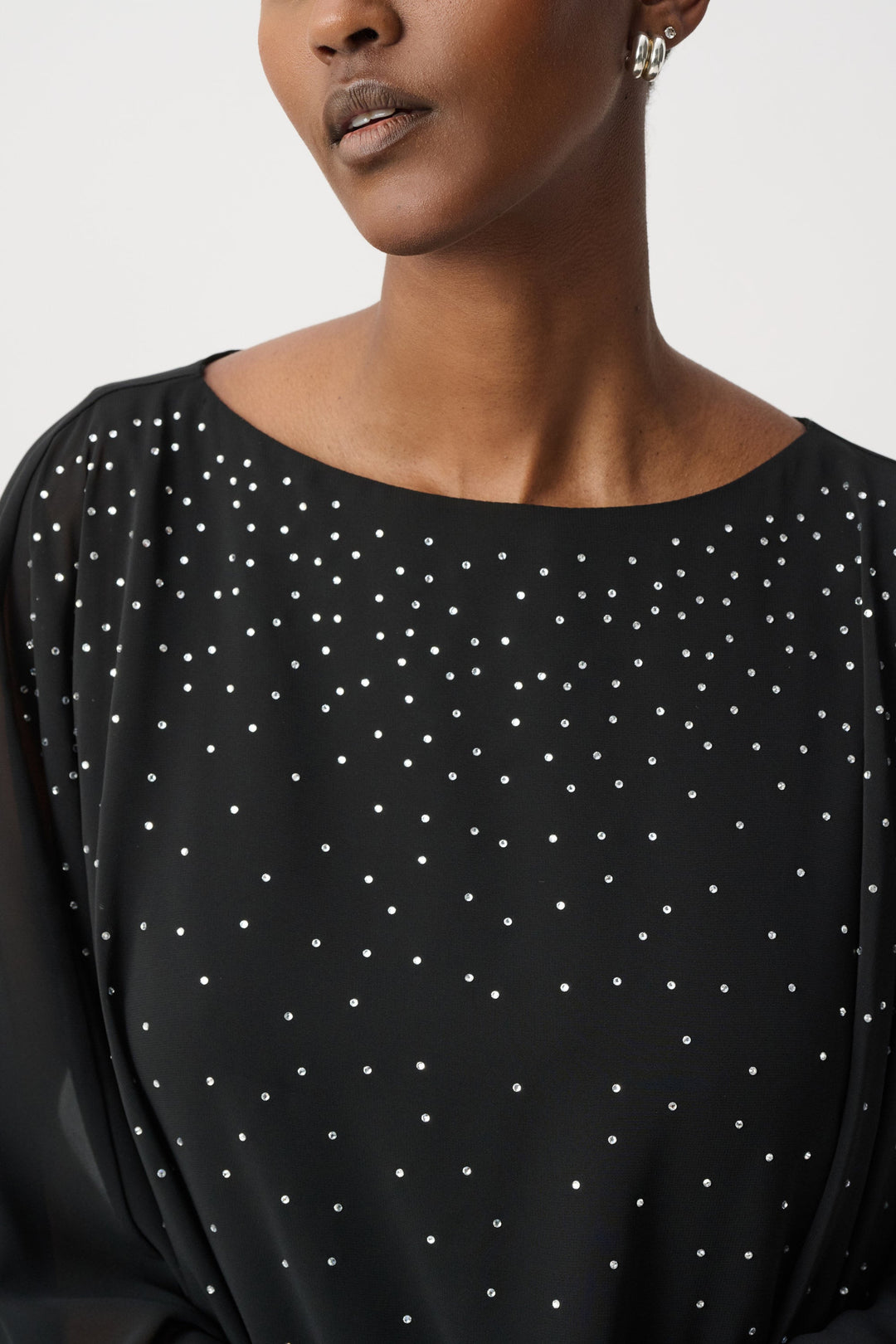 Black rhinestone-dotted poncho top with rounded neckline