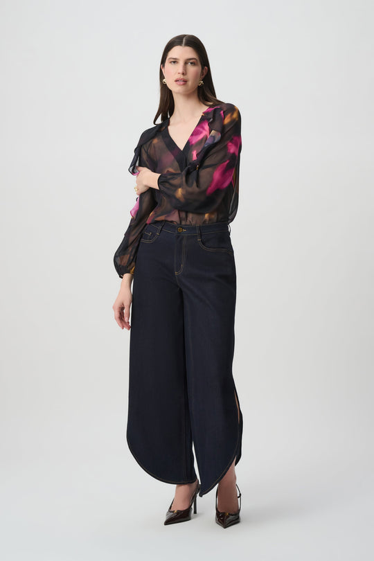 Joseph Ribkoff sheer black multi floral chiffon V-neck ruffle top worn with dark wide-leg jeans