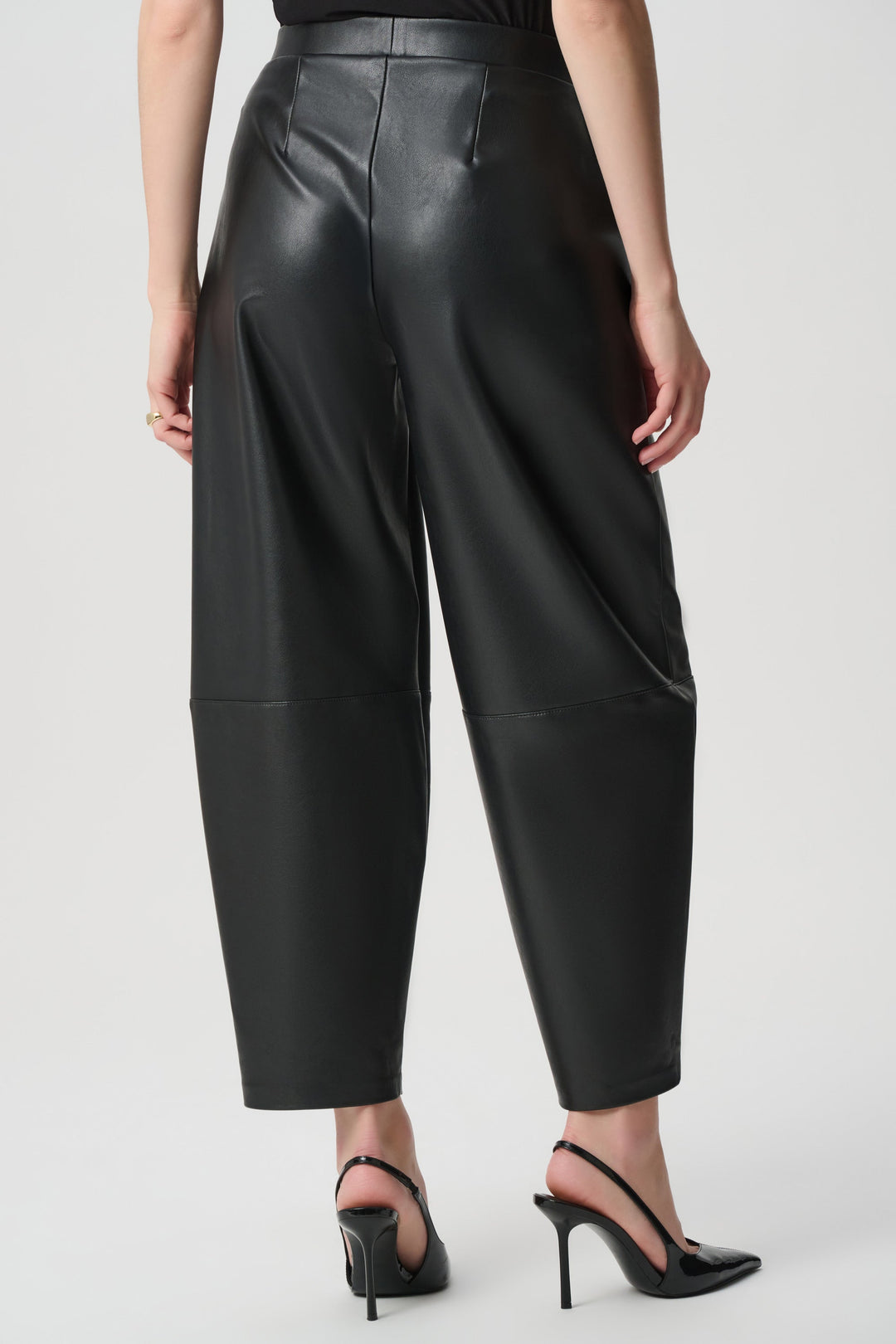 Joseph Ribkoff black leatherette barrel leg pants worn with black slingback heels, back view