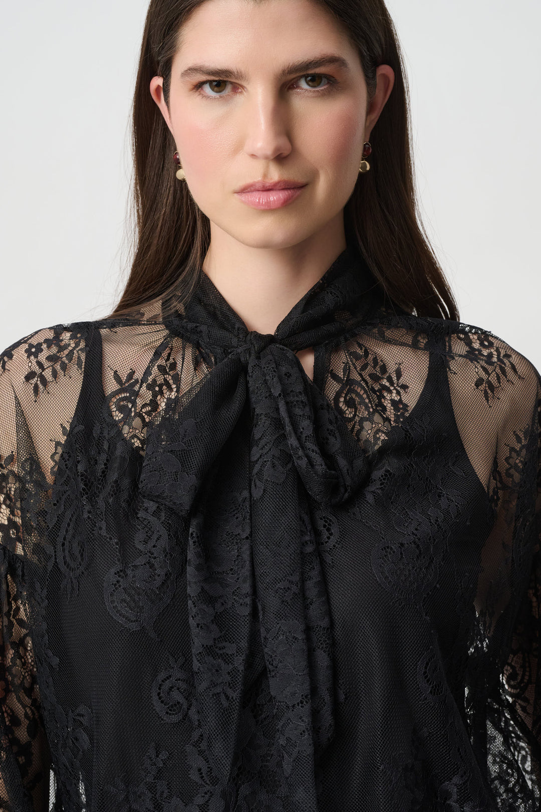 Joseph Ribkoff black lace bow neck blouse with sheer sleeves worn by model