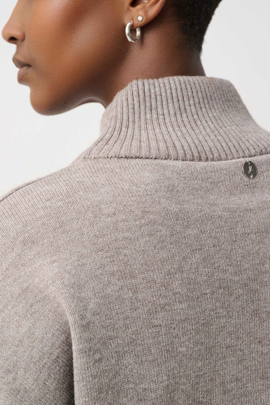 Taupe ribbed turtleneck sweater with small stud embellishments at shoulder