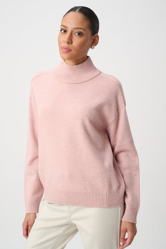 Soft blush embellished turtleneck sweater with ribbed collar, cuffs, and hem