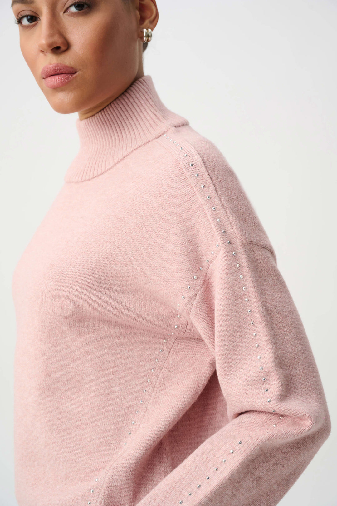Soft blush embellished turtleneck sweater with studded shoulder accents and sleeve