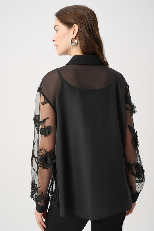 Joseph Ribkoff black sheer blouse with floral applique sleeves, back view