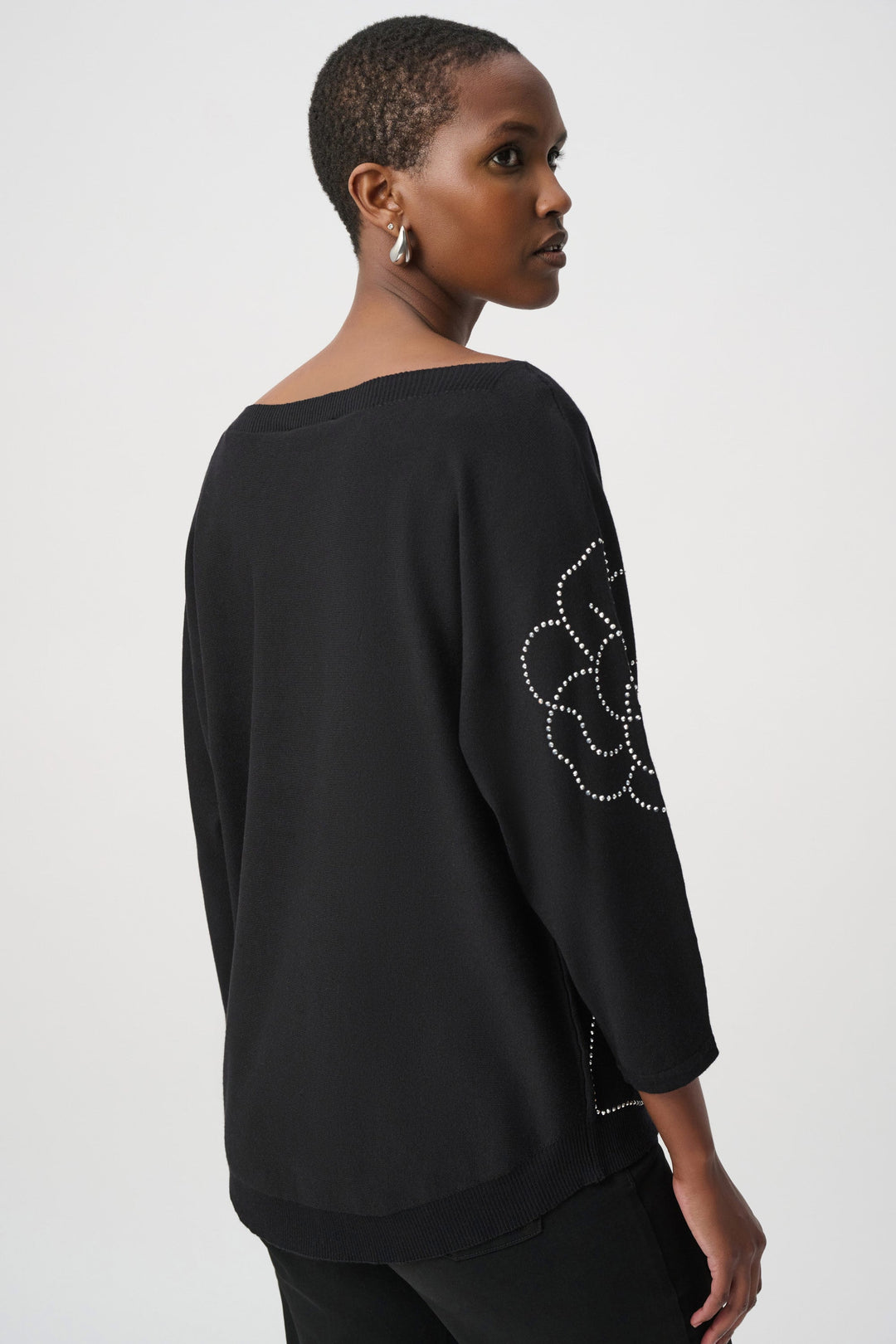 Black pullover sweater with back rhinestone flower applique and three-quarter sleeves