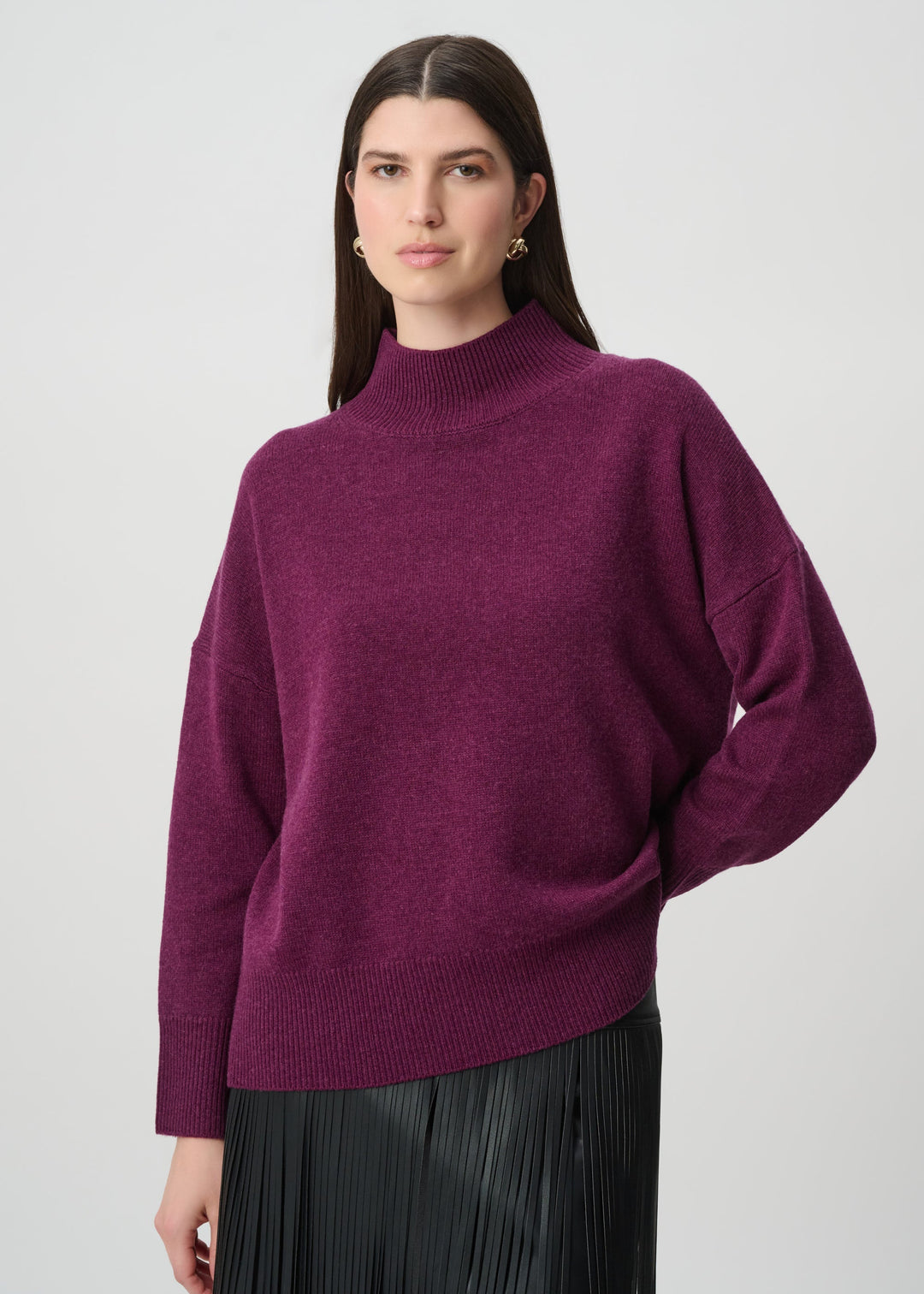 Joseph Ribkoff oversized wool mock neck sweater in elderberry purple, styled with black pleated skirt