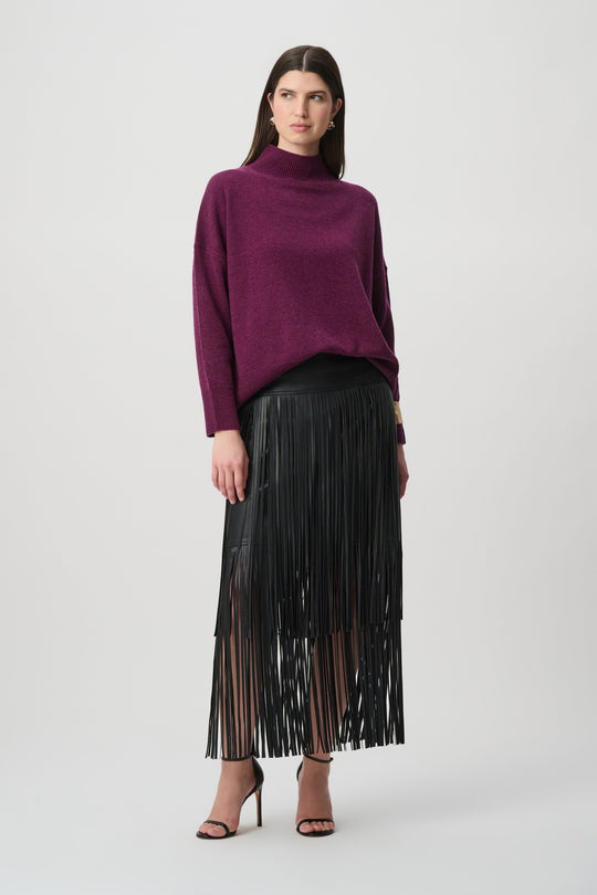 Joseph Ribkoff wool mock neck sweater in elderberry purple paired with black fringe skirt