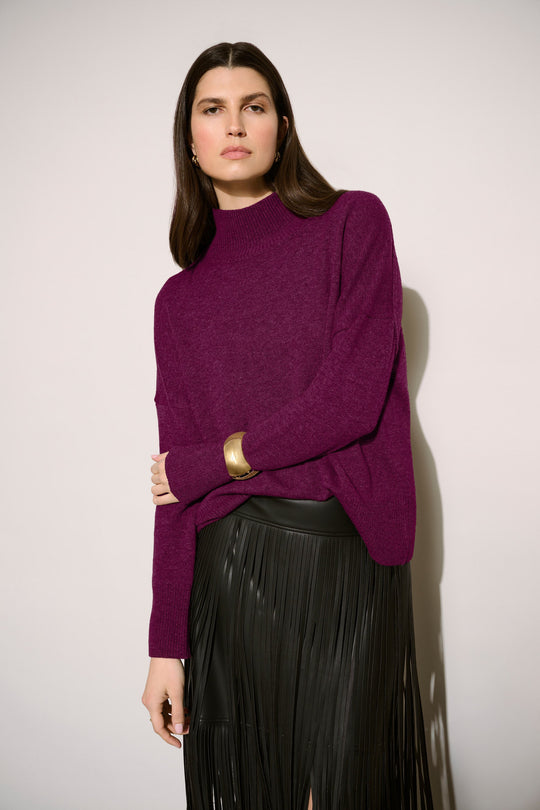Joseph Ribkoff wool mock neck sweater in elderberry purple, styled with black fringe skirt