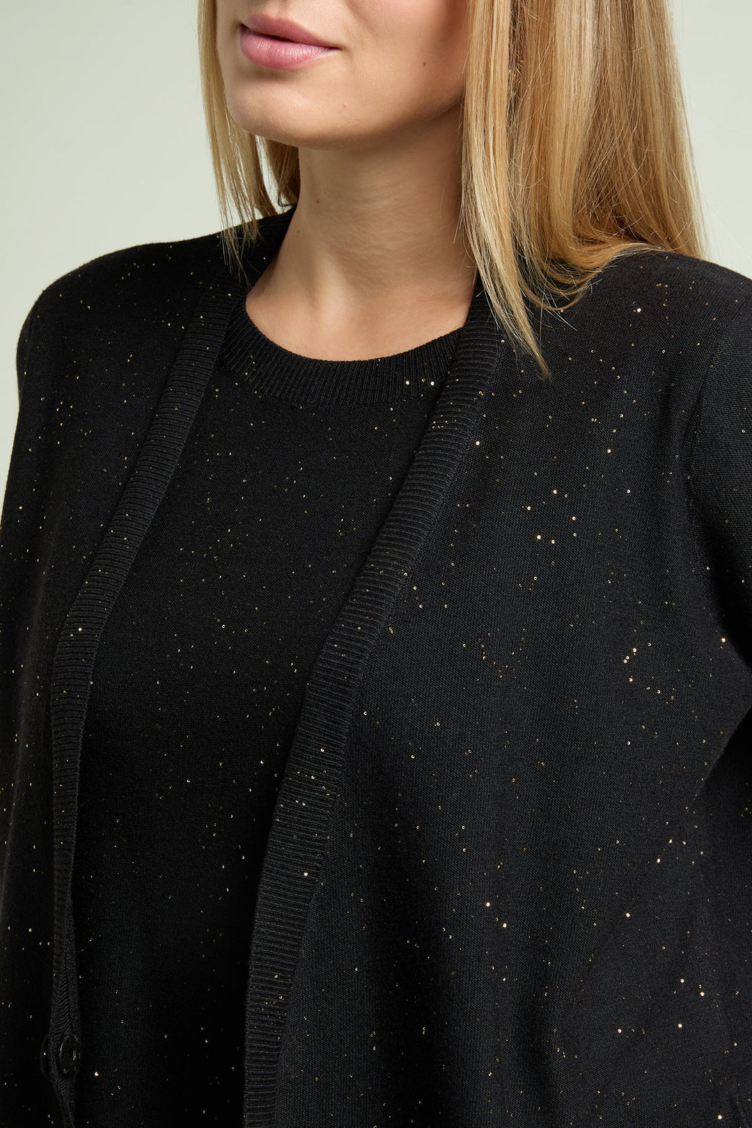 Black top and open jacket close-up with stone-like sparkly specks and round neckline