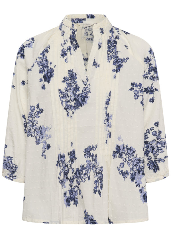 White blouse with blue floral pattern on a white background