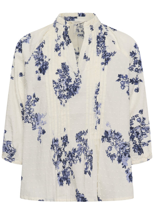 White blouse with blue floral pattern on a white background