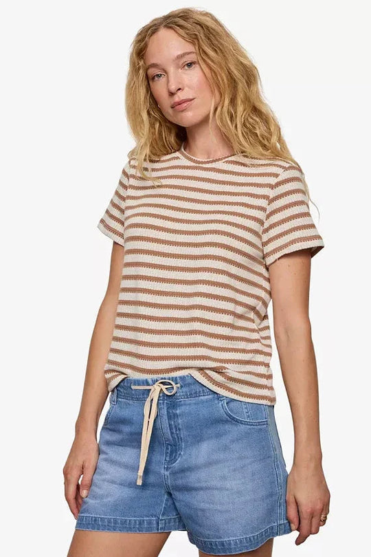 Brown and cream striped short-sleeve textured tee on model with denim shorts