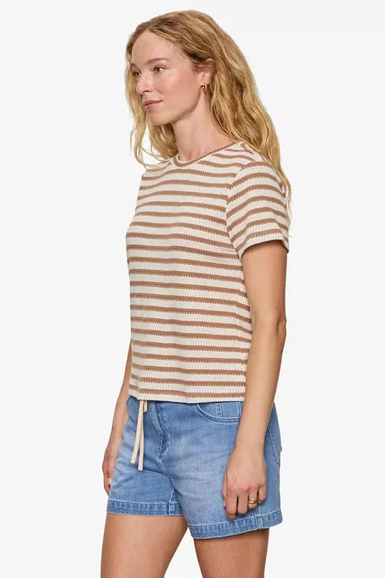 Brown and cream striped short sleeve knit top on model, side view