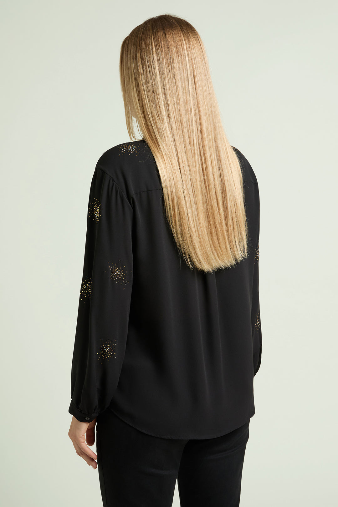 Black long-sleeve blouse with starburst beaded detailing, back view