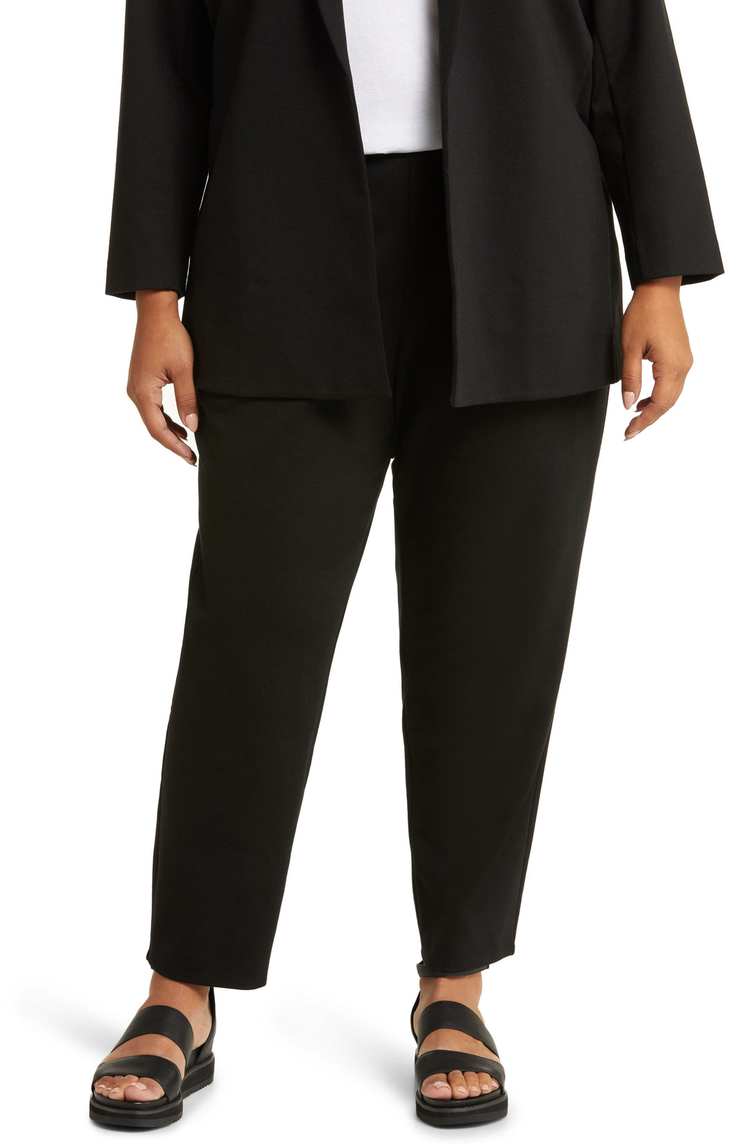 Black tapered ankle pants with slim fit, worn with open blazer and sandals, front view
