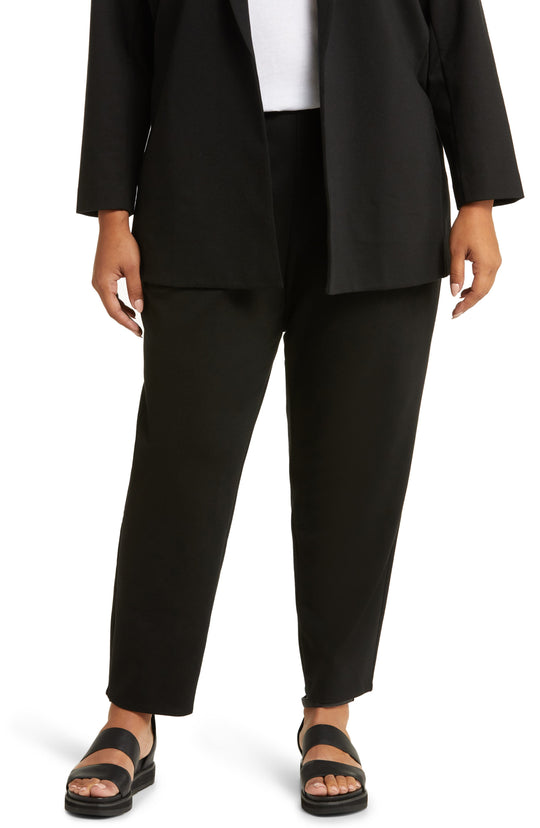 Black tapered ankle pants with slim fit, worn with open blazer and sandals, front view