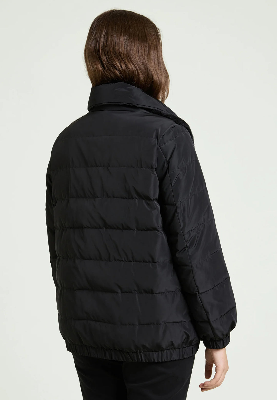 Black puffer jacket back view with quilted stripes and elastic cuffs
