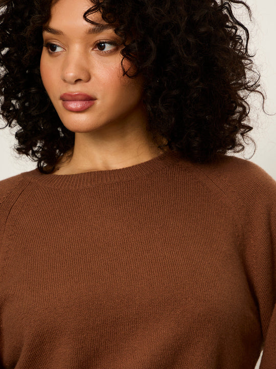 Cocoa brown knit sweater close-up with crewneck and textured ribbed fabric
