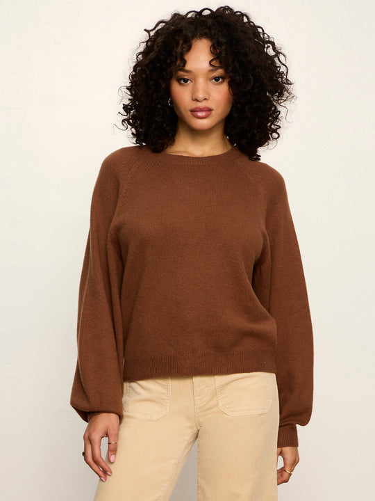 Cocoa brown crewneck knit sweater with long sleeves, worn over light pants