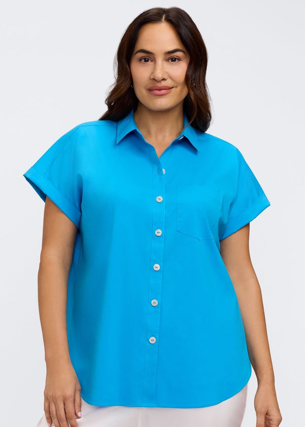 Woman wearing a bright blue shirt on a white background