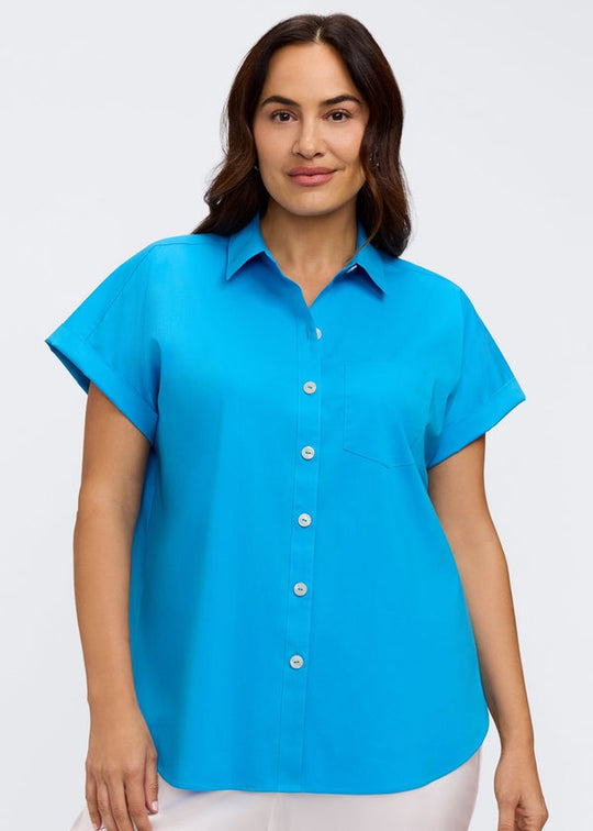 Woman wearing a bright blue shirt on a white background