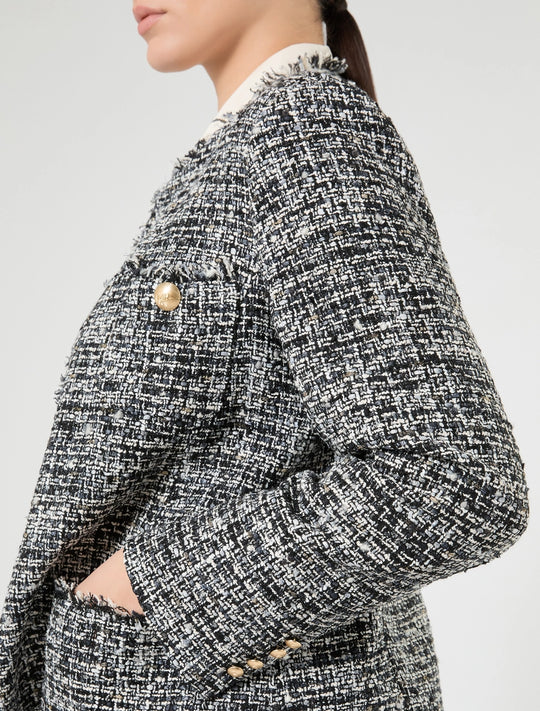 Black and white tweed boucle jacket with gold-tone button details and structured shoulder