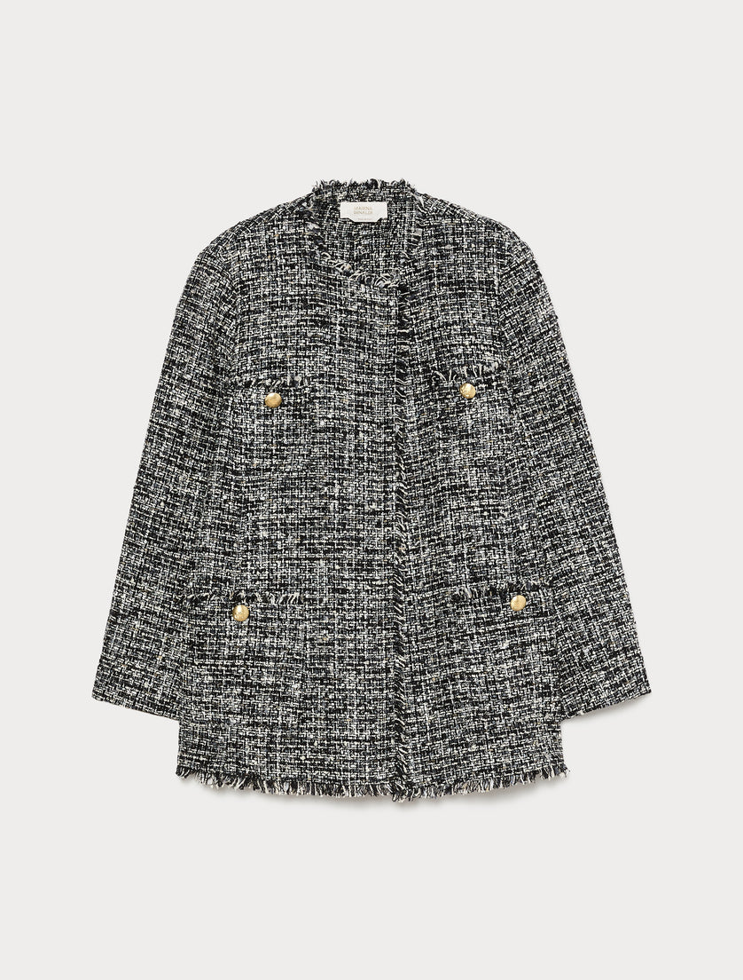 Black and white tweed boucle jacket with gold buttons, frayed edges, and patch pockets, flat lay view