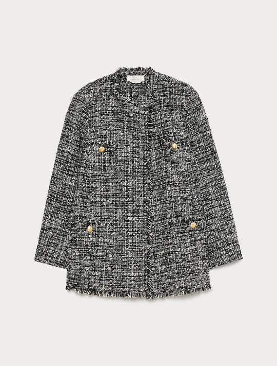 Black and white tweed boucle jacket with gold buttons, frayed edges, and patch pockets, flat lay view
