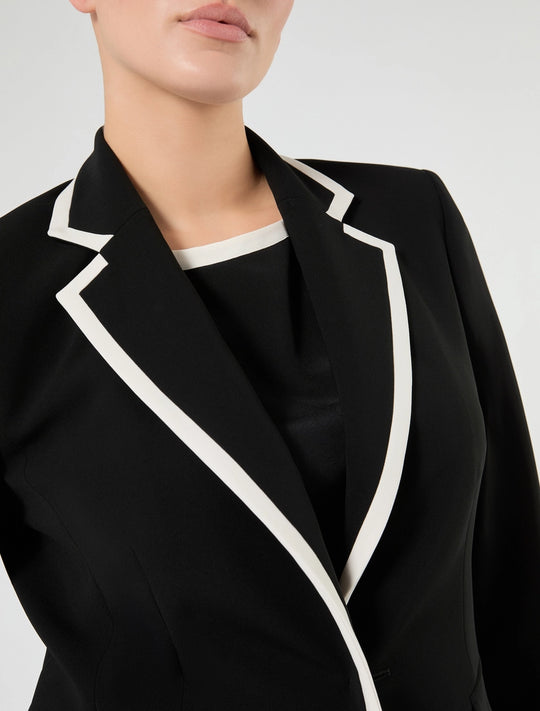 Black blazer with white contrast lapels and piping, notched collar